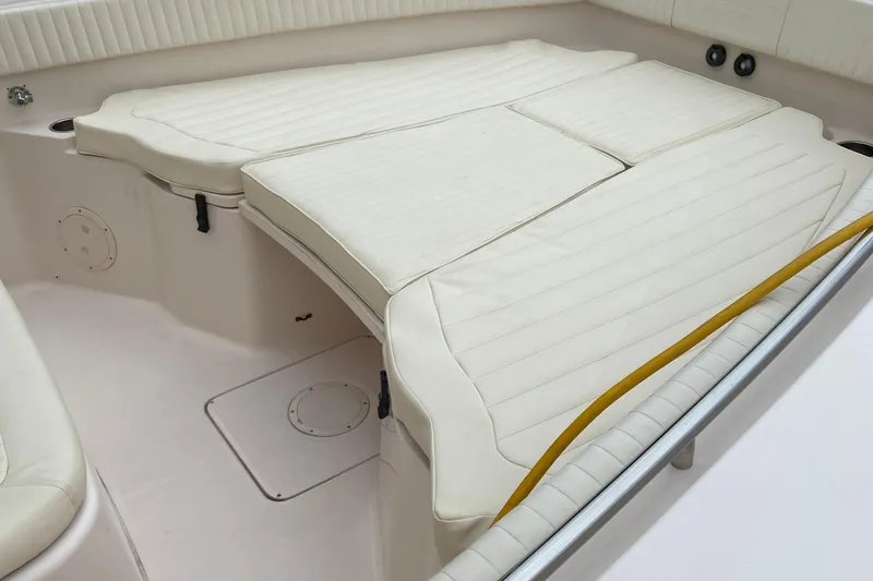 Slide: The Image of 2013 Grady-White Canyon 306 boat interior with cushioned seating area. - 22