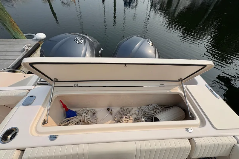 Slide: The Image of 2013 Grady-White Canyon 306 boat storage compartment with ropes and accessories. - 28