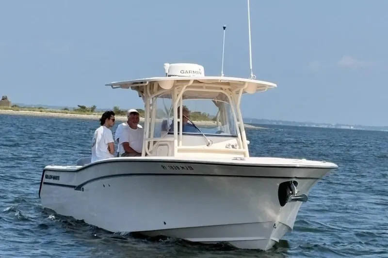 Slide: The Image of 2013 Grady-White Canyon 306 boat on water with three people onboard. - 3