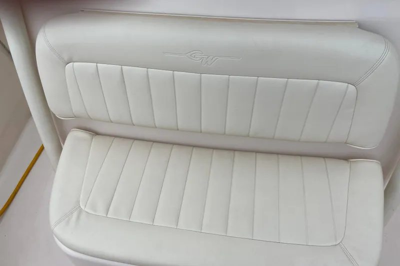 Slide: The Image of White cushioned seat on 2013 Grady-White Canyon 306 boat, featuring embossed logo. - 32