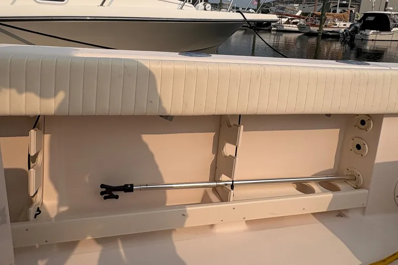 Slide: The Image of 2013 Grady-White Canyon 306 boat interior with rod holders and seating, docked at marina. - 33