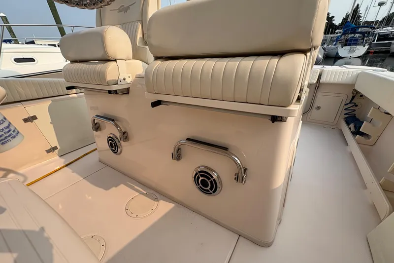 Slide: The Image of 2013 Grady-White Canyon 306 boat interior with cushioned seating and stainless steel fixtures. - 36