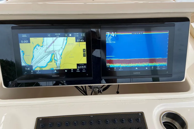 Slide: The Image of Garmin navigation screens on a 2013 Grady-White Canyon 306 boat dashboard. - 39