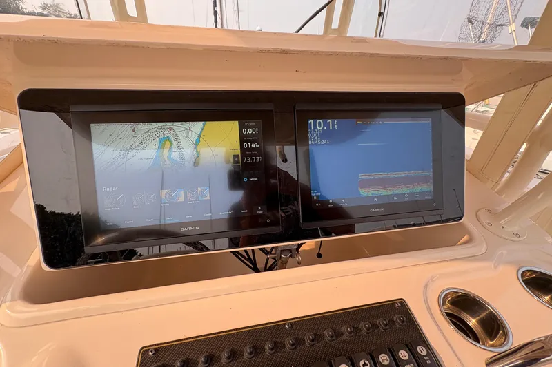 Slide: The Image of 2013 Grady-White Canyon 306 boat dashboard with dual Garmin navigation screens. - 40
