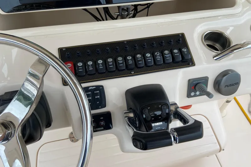 Slide: The Image of Control panel of 2013 Grady-White Canyon 306 boat with steering wheel and switches. - 41