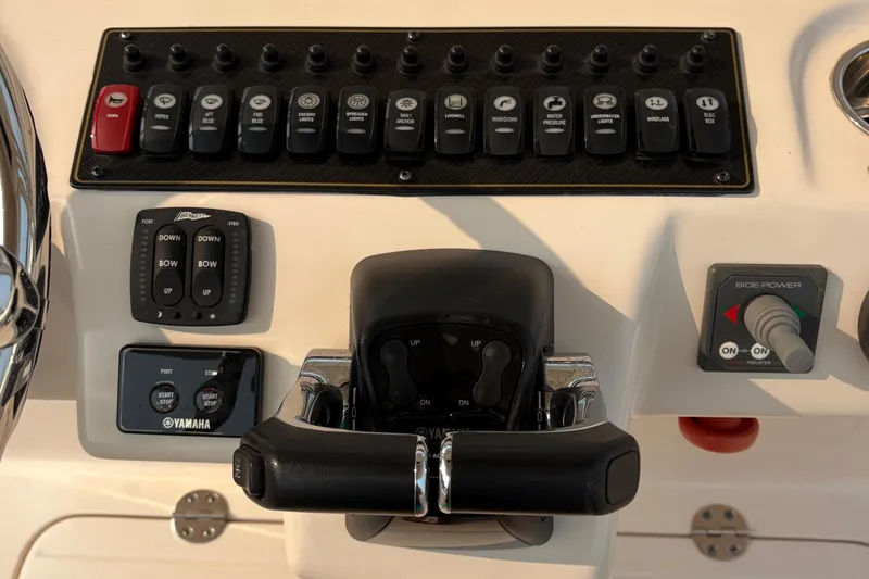 Slide: The Image of Control panel of 2013 Grady-White Canyon 306 boat with switches and throttle. - 42