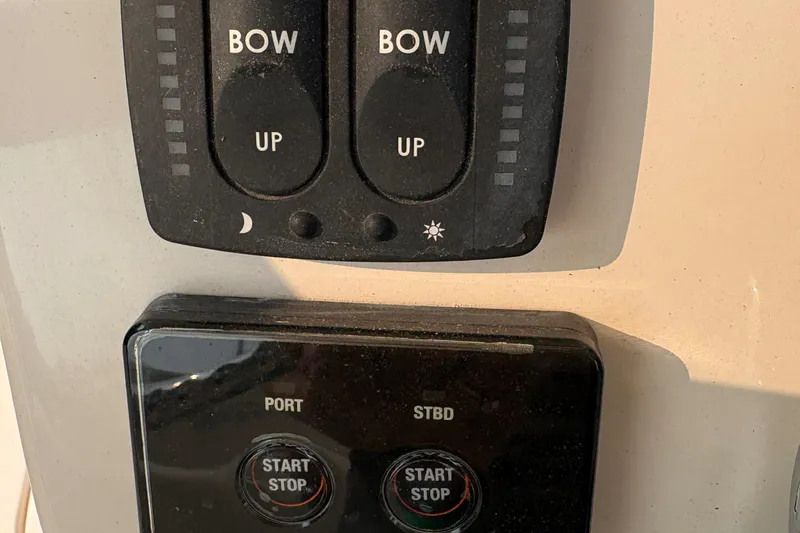 Slide: The Image of Control panel of a 2013 Grady-White Canyon 306 boat with bow and engine switches. - 44