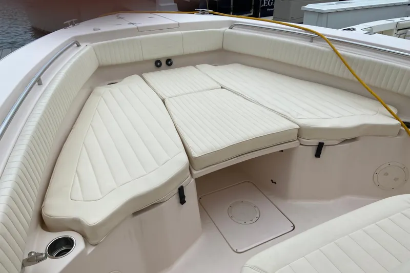 Slide: The Image of 2013 Grady-White Canyon 306 boat interior with cushioned seating and cup holders. - 49