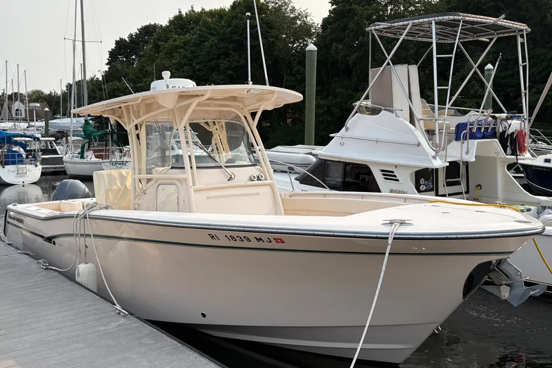 Slide: The Image of 2013 Grady-White Canyon 306 boat docked at marina with other vessels. - 5