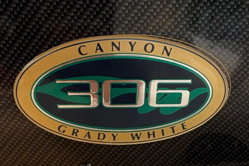 Slide: The Image of Grady-White Canyon 306 logo on carbon fiber background, 2013 model. - 51