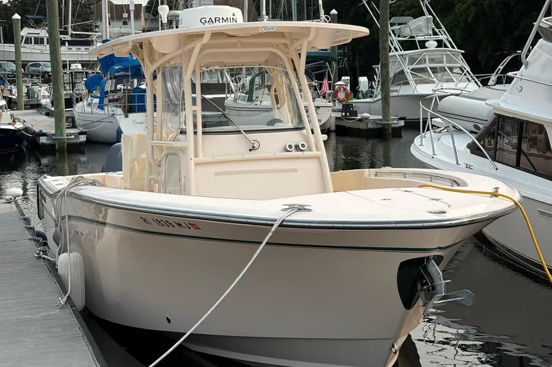 Slide: The Image of 2013 Grady-White Canyon 306 boat docked at marina with other vessels. - 6