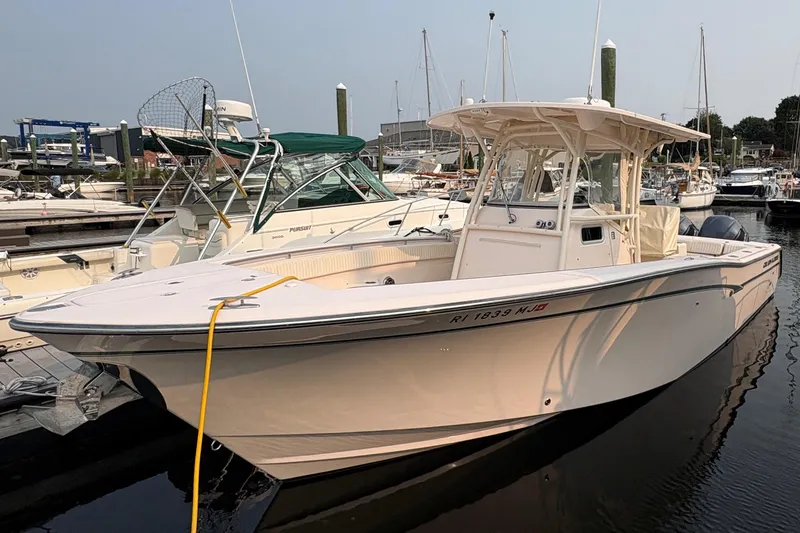 Slide: The Image of 2013 Grady-White Canyon 306 boat docked in a marina, side view. - 7