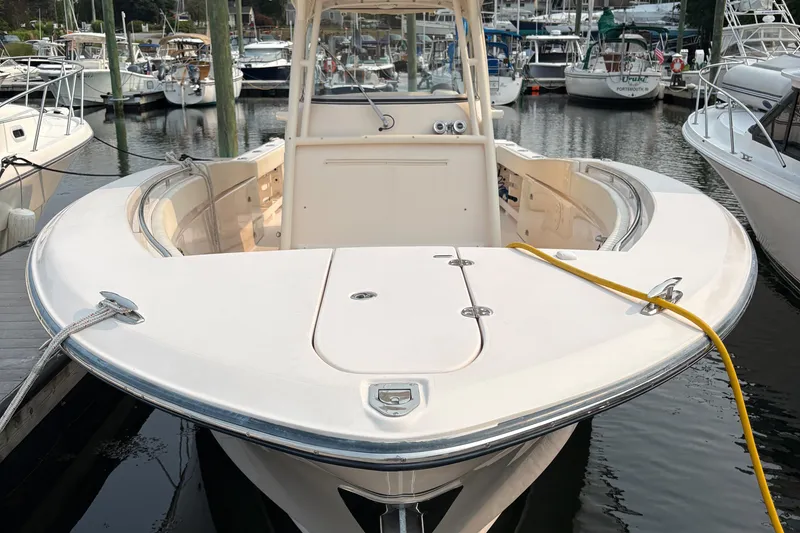 Slide: The Image of 2013 Grady-White Canyon 306 boat docked in a marina, surrounded by other vessels. - 8
