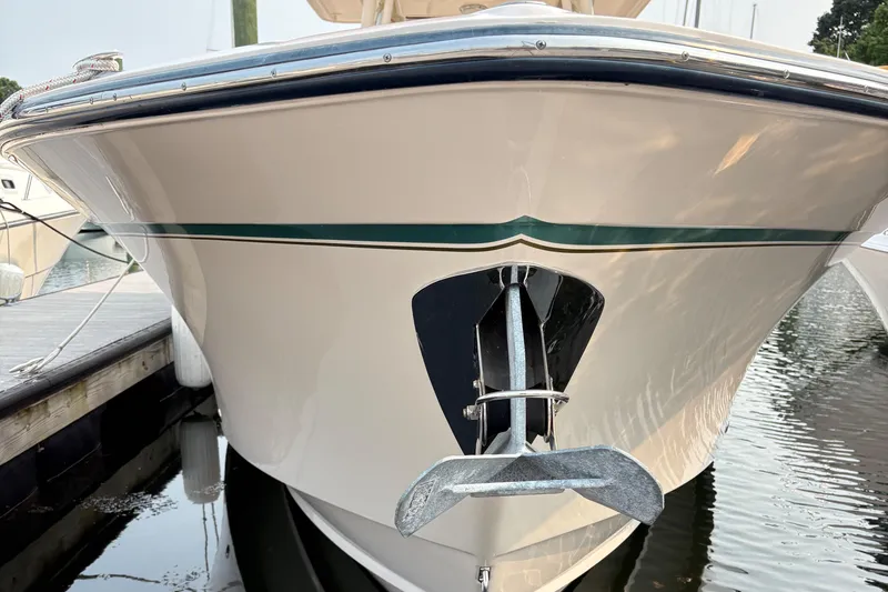 Slide: The Image of 2013 Grady-White Canyon 306 boat anchored at a marina, front view. - 9