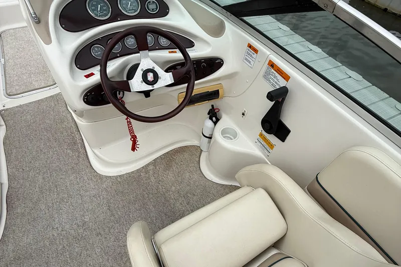 Slide: The Image of Interior of 2000 Chris-Craft 230 Deck Boat with steering wheel and control panel. - 5