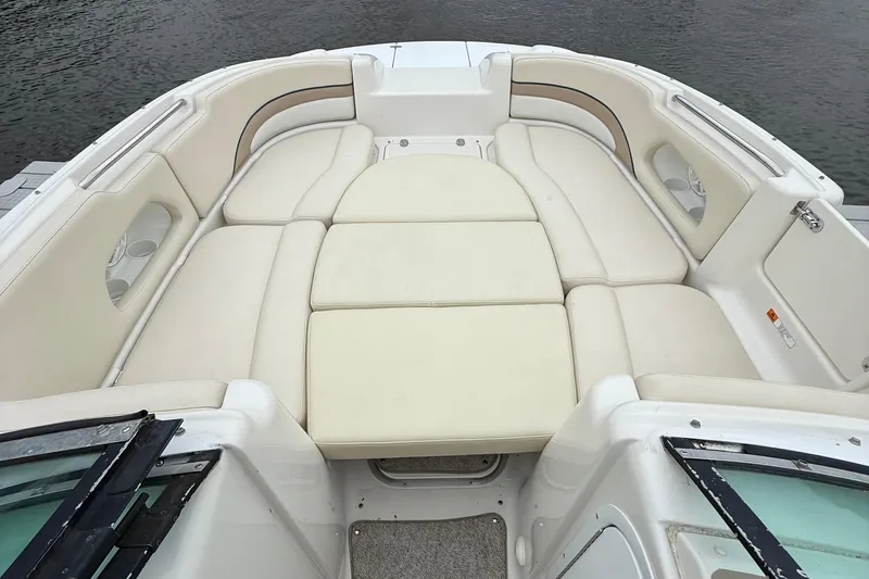 Slide: The Image of 2000 Chris-Craft 230 Deck Boat with spacious seating and beige upholstery. - 7