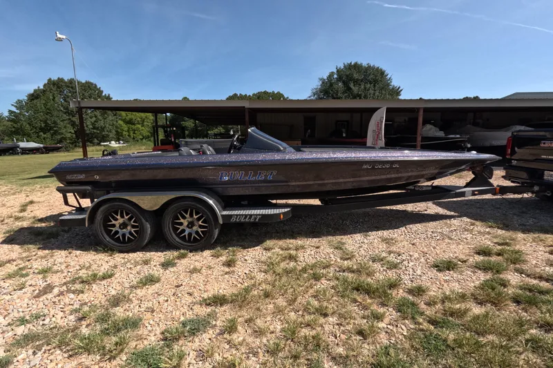 The Image of 2021 Bullet 21XRS boat on trailer, parked outdoors under clear sky. - 0
