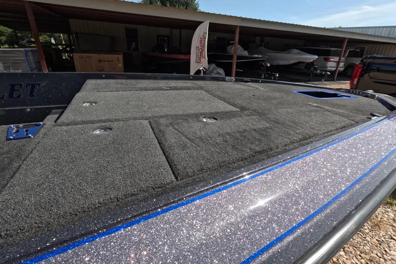 Slide: The Image of 2021 Bullet 21XRS boat deck with carpeted surface and storage compartments. - 3