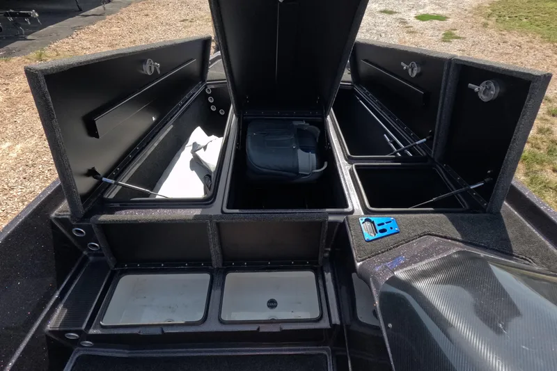Slide: The Image of 2021 Bullet 21XRS boat storage compartments open, showcasing spacious interior design. - 4
