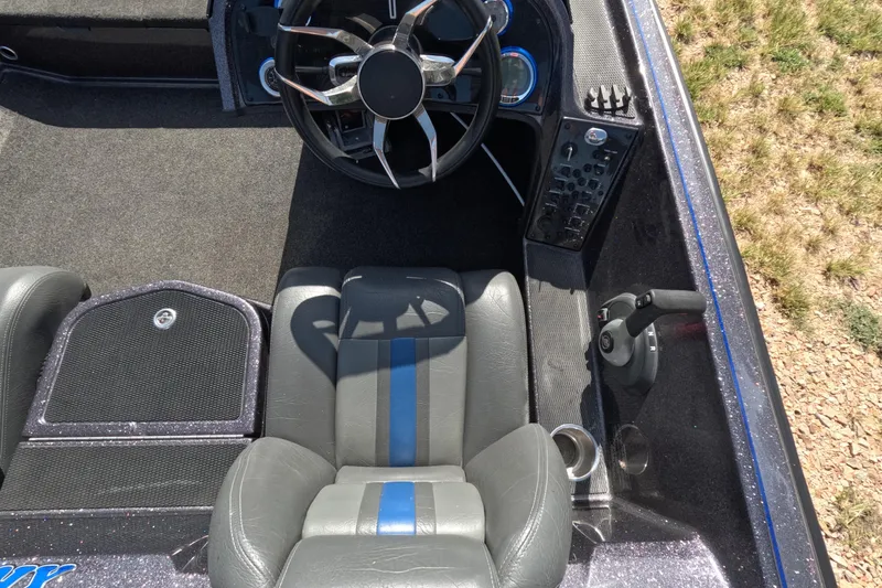 Slide: The Image of Interior of a 2021 Bullet 21XRS boat featuring steering wheel and control panel. - 7