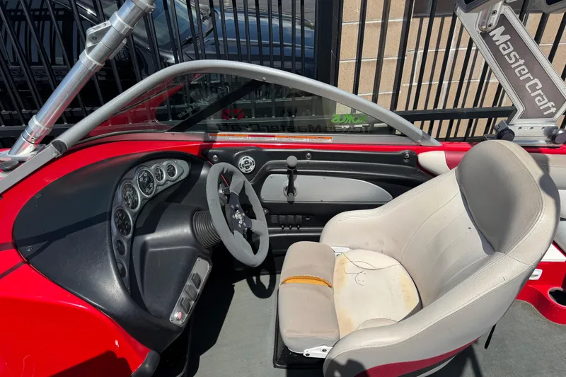 Slide: The Image of 2008 MasterCraft X1 boat interior with steering wheel and worn seat. - 4