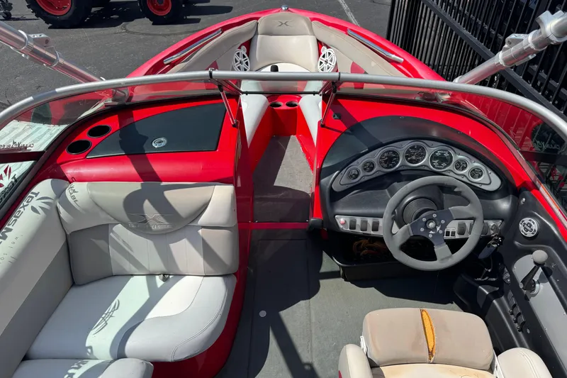 Slide: The Image of 2008 MasterCraft X1 boat interior with red and white seating, steering wheel, and dashboard controls. - 5