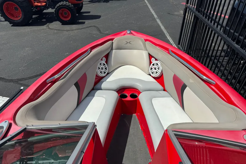 Slide: The Image of 2008 MasterCraft X1 boat interior with red and gray seating, cup holders, and speakers. - 6