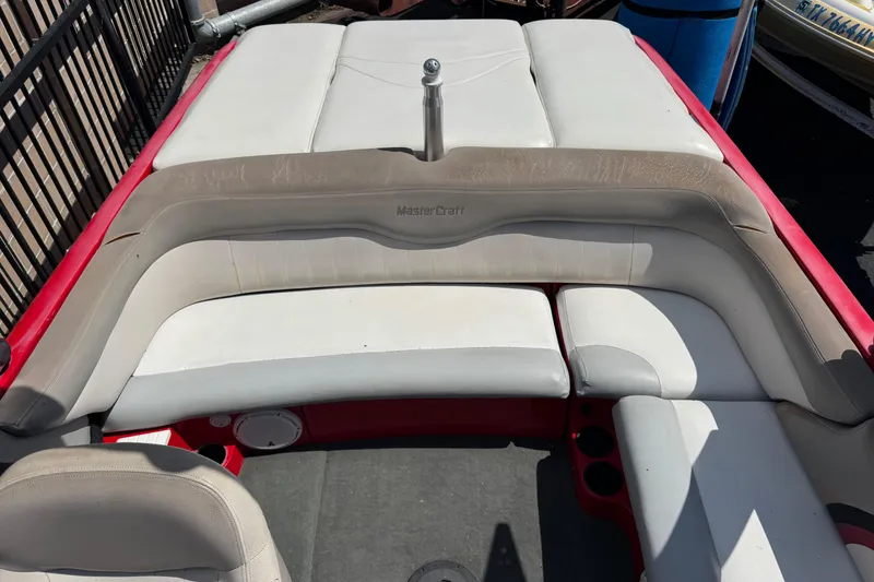Slide: The Image of 2008 MasterCraft X1 boat interior with white and red seating, showing wear. - 7