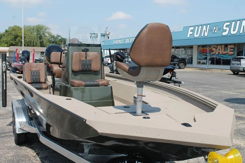 Slide: The Image of 2026 Excel Bay Pro Elite 220 boat displayed at dealership, featuring sleek design and comfortable seating. - 6
