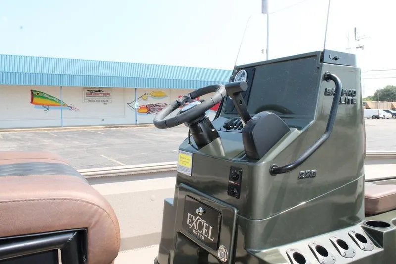 Slide: The Image of 2026 Excel Bay Pro Elite 220 boat console with steering wheel and controls. - 8