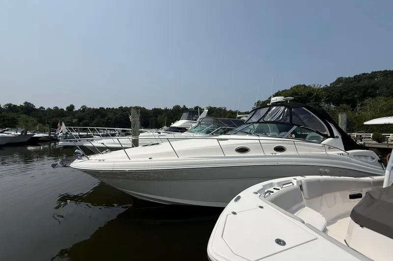 The Image of 2003 Sea Ray 340 Sundancer yacht docked at marina, surrounded by other boats. - 0