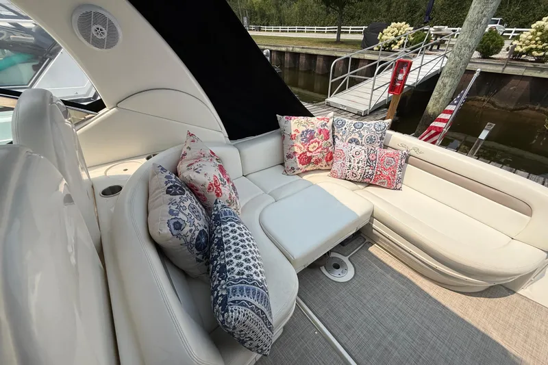Slide: The Image of Luxurious 2003 Sea Ray 340 Sundancer boat interior with plush seating and decorative pillows. - 10
