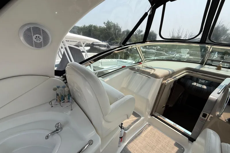 Slide: The Image of Interior view of 2003 Sea Ray 340 Sundancer yacht, featuring helm and seating area. - 14
