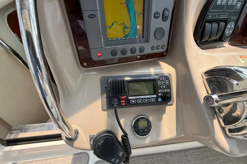 Slide: The Image of Control panel of a 2003 Sea Ray 340 Sundancer with navigation and communication equipment. - 17