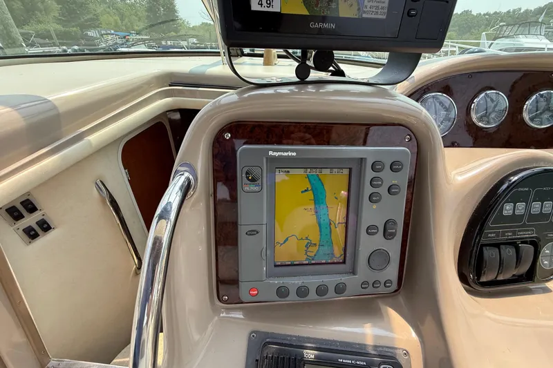 Slide: The Image of Control panel of a 2003 Sea Ray 340 Sundancer with navigation system and gauges. - 19