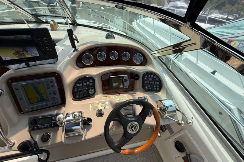 Slide: The Image of 2003 Sea Ray 340 Sundancer helm with navigation instruments and steering wheel. - 22