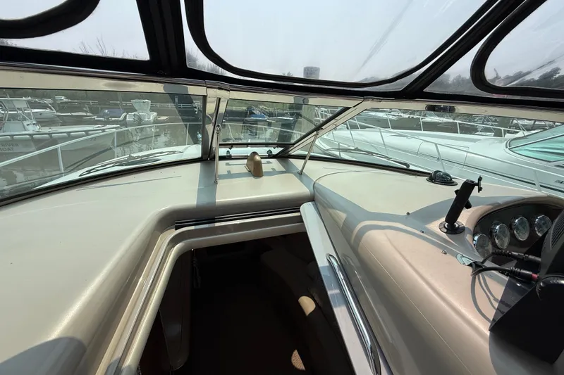 Slide: The Image of 2003 Sea Ray 340 Sundancer helm with gauges and marina view through windshield. - 23
