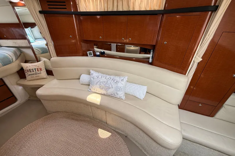 Slide: The Image of Luxurious interior of 2003 Sea Ray 340 Sundancer with curved seating and decorative pillows. - 24