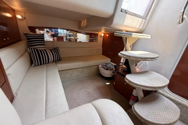 Slide: The Image of Interior of 2003 Sea Ray 340 Sundancer yacht with cozy seating and spiral staircase. - 27