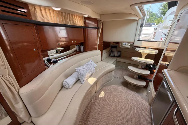 Slide: The Image of Luxurious interior of a 2003 Sea Ray 340 Sundancer yacht with elegant seating and wooden cabinetry. - 28