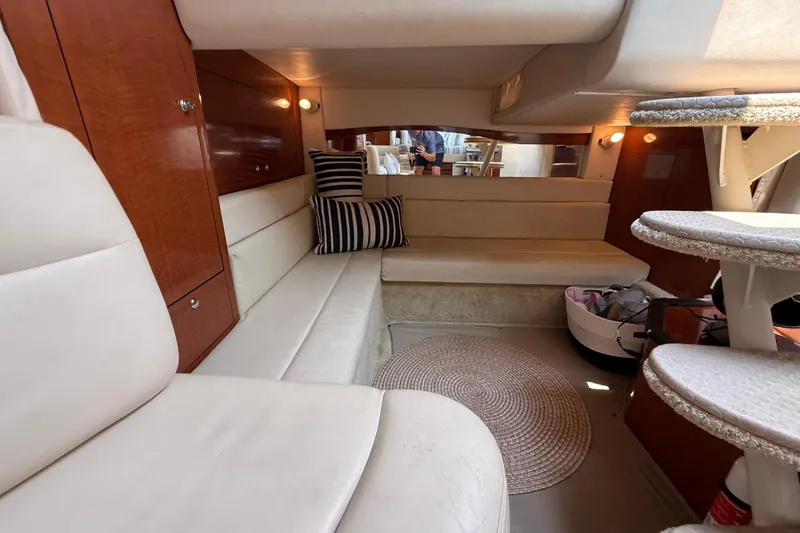 Slide: The Image of 2003 Sea Ray 340 Sundancer cabin interior with plush seating and elegant wood finishes. - 31