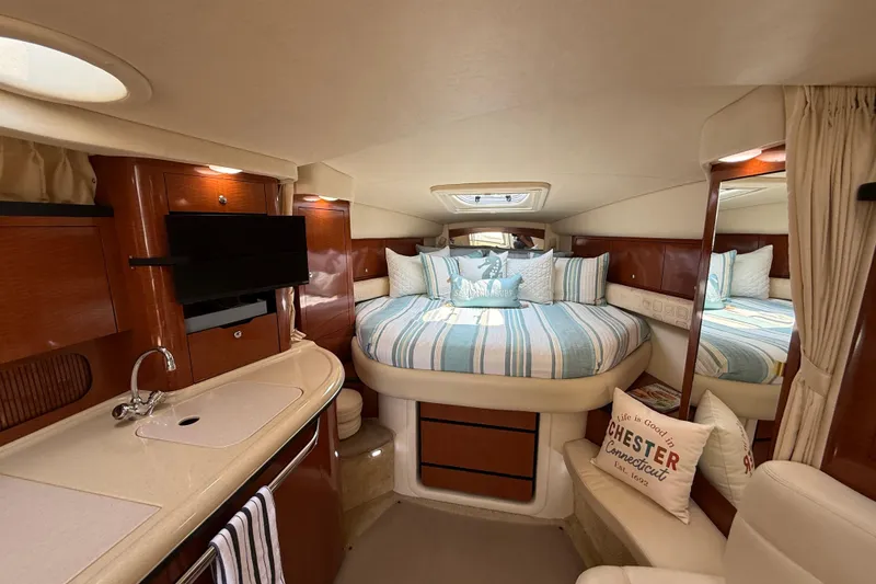 Slide: The Image of Luxurious interior of 2003 Sea Ray 340 Sundancer yacht with cozy bed and kitchenette. - 32