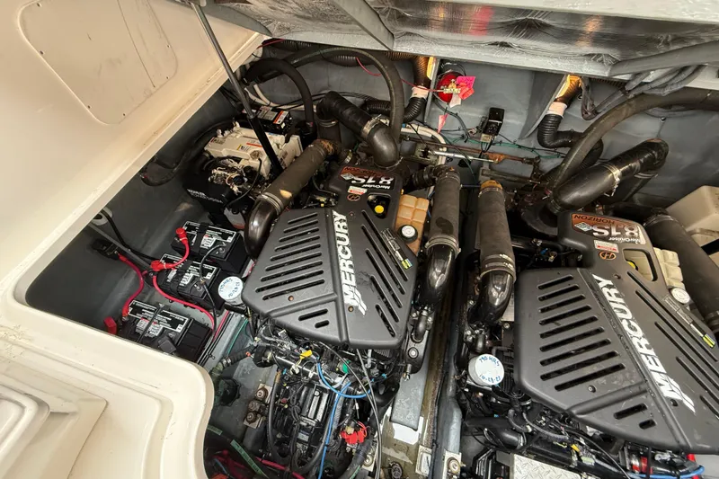 Slide: The Image of Engine compartment of a 2003 Sea Ray 340 Sundancer with Mercury engines. - 42