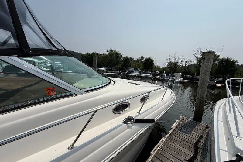 Slide: The Image of 2003 Sea Ray 340 Sundancer docked at a marina, side view. - 5