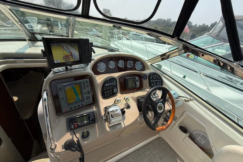 Slide: The Image of Cockpit of 2003 Sea Ray 340 Sundancer with navigation equipment and steering wheel. - 7