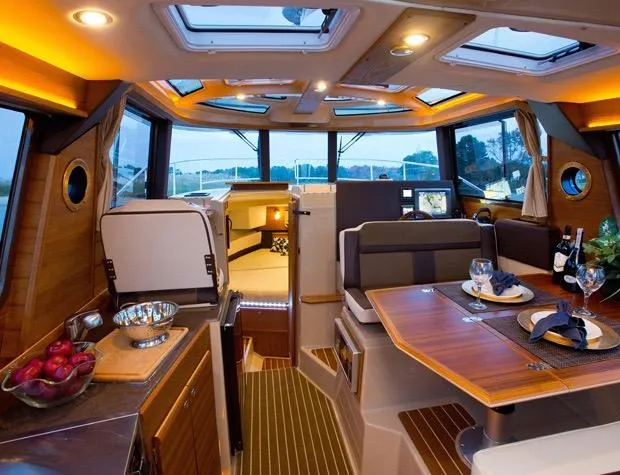 Slide: The Image of Manufacturer Provided Image: Luxurious 2025 Ranger Tugs R-29 S interior with elegant dining and kitchen area. - 13