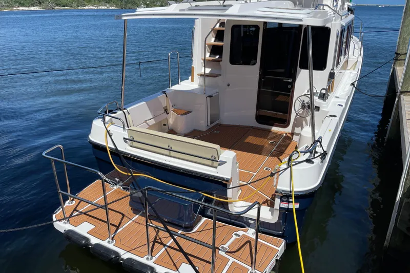 Slide: The Image of 2026 Ranger Tugs R-29 S docked, showcasing spacious deck and modern design. - 3