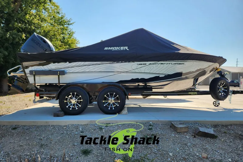 Slide: The Image of 2026 Smoker Craft Adventurer 188 DC PRO boat on trailer, covered, outdoors. - 0