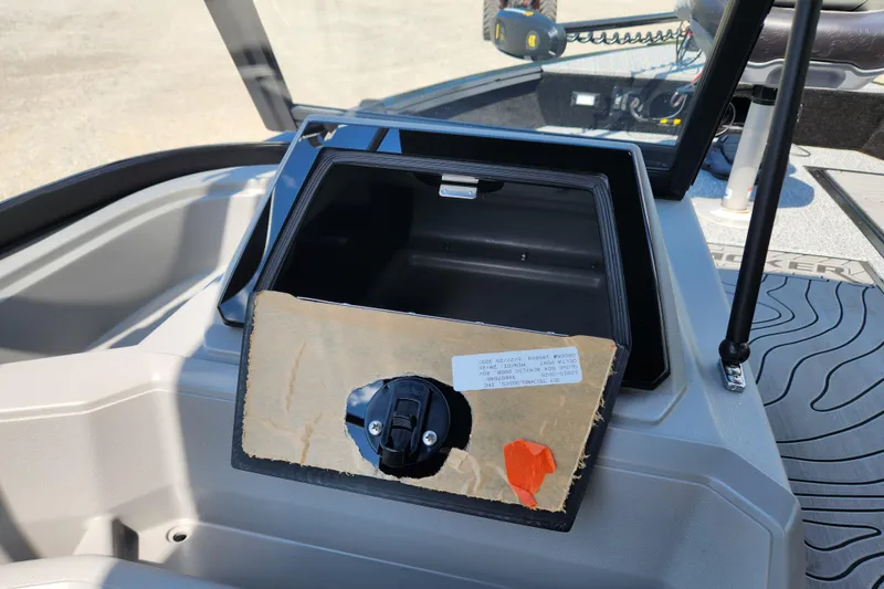 Slide: The Image of 2026 Smoker Craft Adventurer 188 DC PRO boat dashboard with open storage compartment. - 13