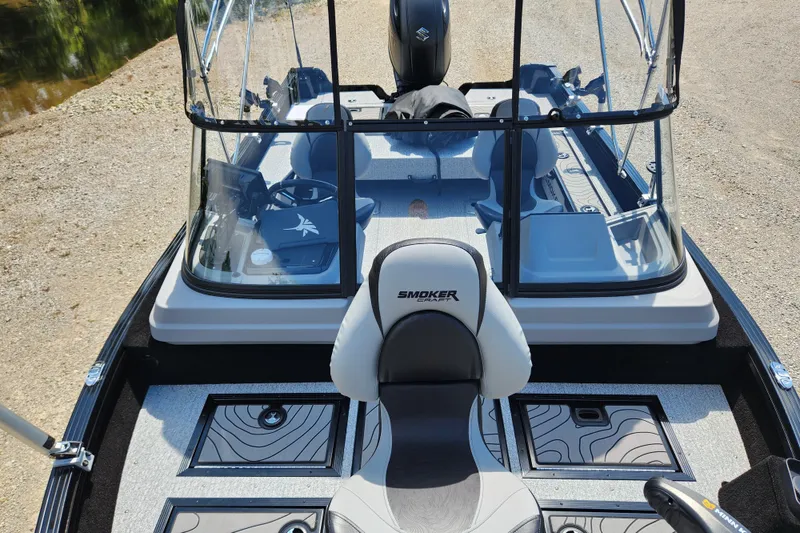 Slide: The Image of 2026 Smoker Craft Adventurer 188 DC PRO boat interior with seating and control panel. - 14
